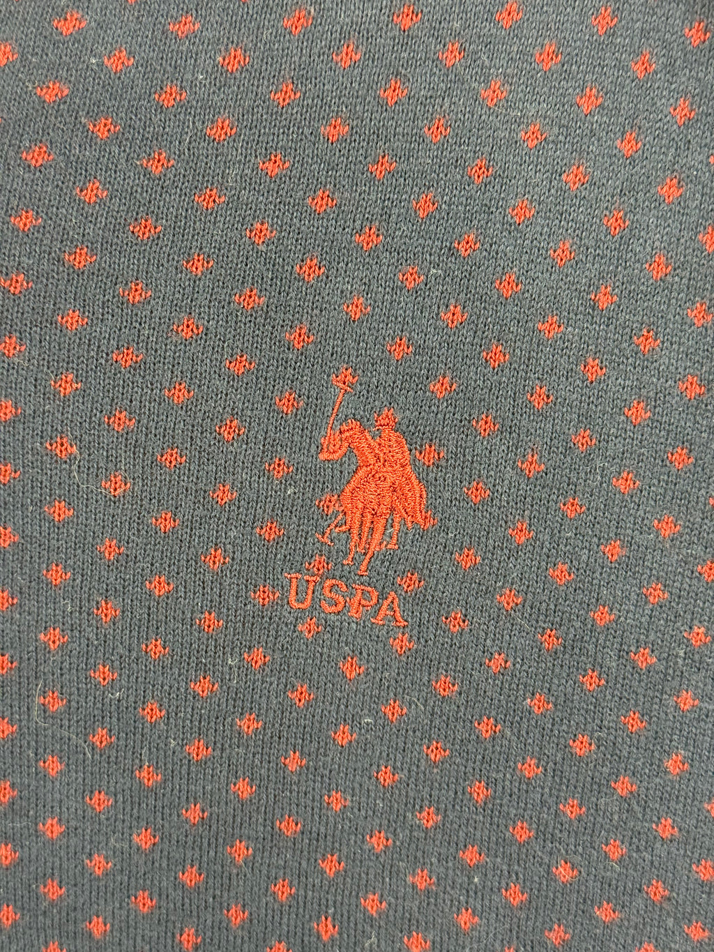 Embroidered USPA chest logo and red knit pattern