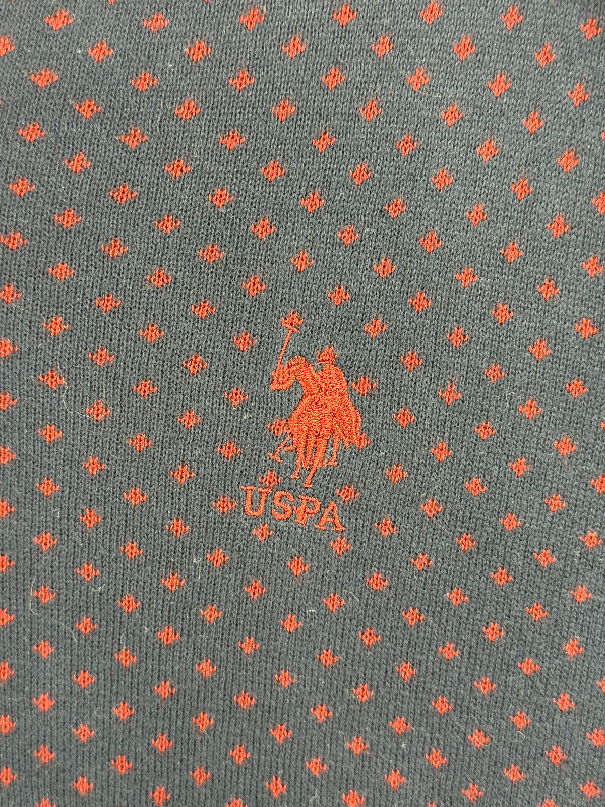 Embroidered USPA chest logo and red knit pattern